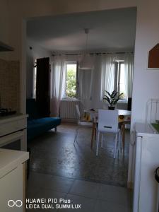 a kitchen and living room with a blue couch and a table at Villa Galilei Rooms in Pisa +22 photos