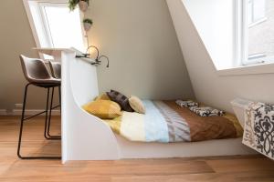 een slaapkamer met een bed in de hoek van een kamer bij Saint Claire Studio's in Amsterdam