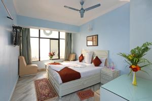 a bedroom with a bed and a large window at Hotel Niladri in Puri