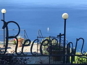 a wrought iron fence with a view of the ocean at Albergo Luna di Marzo in Volastra