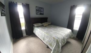 a bedroom with a bed with a teddy bear on it at Spacious Frontier Park Apartment in Erie