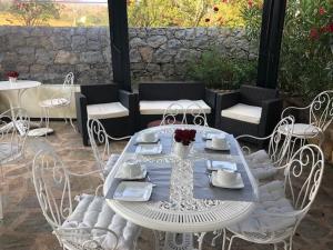 a white table and chairs on a patio at L'Acqua Viva in Calacuccia