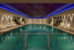 a swimming pool in a hotel with a purple ceiling at The Mira Hong Kong in Hong Kong