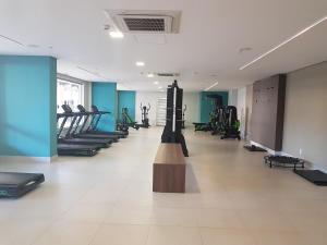a gym with rows of treadmills and machines at Flat Olímpia Park Resort in Olímpia