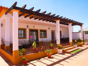 a house with a patio with potted plants at Chalé Chafaris D'el Rei in Elvas