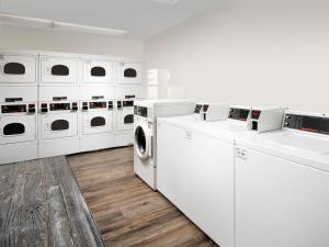 a white laundry room with white washers and dryers at WoodSpring Suites Allentown Bethlehem in Bethlehem