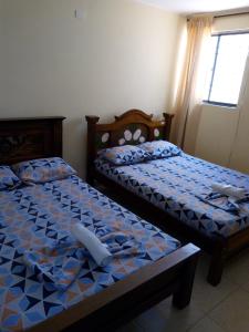 Postel nebo postele na pokoji v ubytování Hotel Táchiras