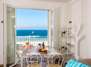 a dining room with a table and a view of the ocean at Beach Residence in Gabicce Mare