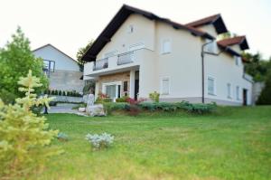 a large white house with a yard in front of it at MAPLE place in Pivka