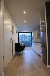 a kitchen and dining room with a large window at Wohnkomfort wie Zuhause in Neubrandenburg