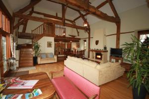 a living room with a couch and a table at Holiday home Le Pressoir in Domfront