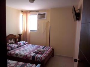 Postel nebo postele na pokoji v ubytování Hotel Táchiras
