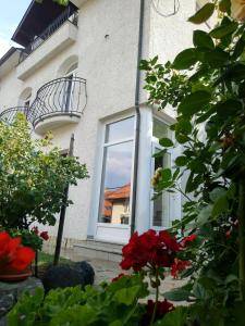 a house with a window and flowers in front of it at Apartman "Kruna" in Belgrade