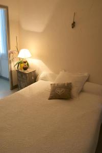 a bedroom with a white bed with a pillow on it at Central Hotel in Niort