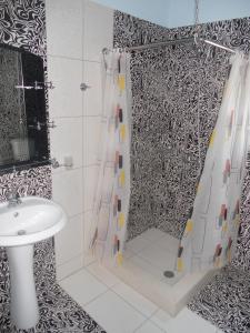 a bathroom with a shower curtain and a sink at Villa Braho 1 in Pogradec
