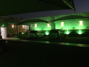 two cars parked in a parking lot at night at Flat & Residence Premium - Apês mobiliados e bem equipados in Campo Grande