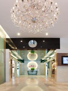 a large chandelier in a lobby with flowers on display at Silka Maytower Kuala Lumpur in Kuala Lumpur