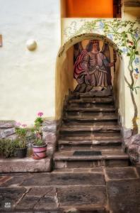 a set of stairs with a painting on the wall at OkiDoki Cusco Hostal in Cusco