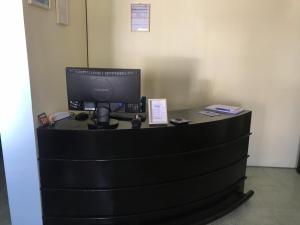 a black desk with a computer on top of it at Hostal Bernardo Salta in Salta