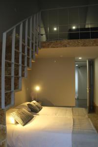 a bedroom with a white bed with a staircase at StayInn City - Póvoa de Varzim in Póvoa de Varzim