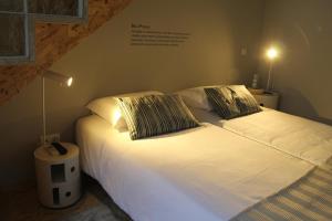 a bed with two pillows on it in a room at StayInn City - Póvoa de Varzim in Póvoa de Varzim