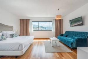 a hotel room with a bed and a couch at Casas do Forte do Pico in Funchal