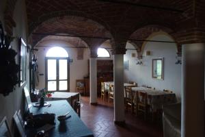 a room with tables and chairs in a building at Monte Bibele in Monterenzio