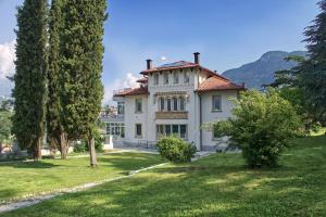 a large white house with trees on a lawn at Trento nel verde in Trento