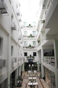 um corredor de um prédio de apartamentos com mesas nele em Hotel Family em São Paulo