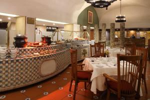 a restaurant with tables and chairs with food on display at Emporio Zacatecas in Zacatecas