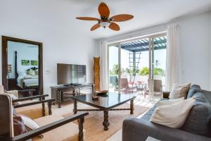 a living room with a couch and a table at Las Terrazas Resort in San Pedro