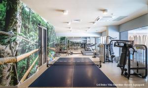 a gym with tread machines and a wall with plants at Studio Elegance in Golden Sands