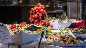 a buffet of food with grapes and other salads at Studio Elegance in Golden Sands