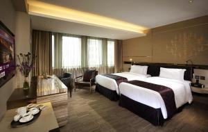 Uma cama ou camas num quarto em Nathan Hotel