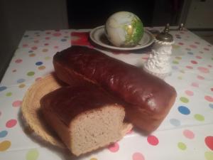 a hot dog and a piece of bread on a table at Agrojelonki Agroturystyka in Gietrzwałd