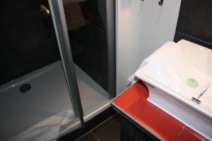 a bathroom with a shower and a red box at Elements Hotel in Regensburg