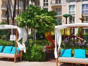 two chairs with blue pillows in a garden at Apartments Anna on the Sunny beach in Sunny Beach