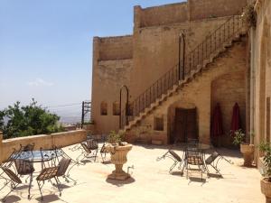 a group of chairs and tables on a patio at Kasr-i Abbas Hotel in Mardin