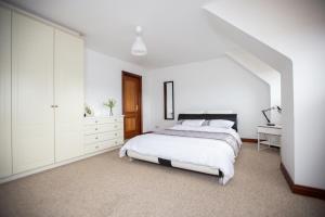 a white bedroom with a bed and a desk at Luxury Manor, Private, Double Garage, Hot tub, Wifi in Ballinderry Upper