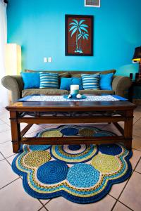 a living room with a couch and a table at Stay in Tamarindo Condominiums in Tamarindo