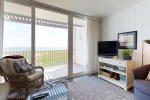 a living room with a television and a balcony at La Playa Condominium 209 in South Padre Island