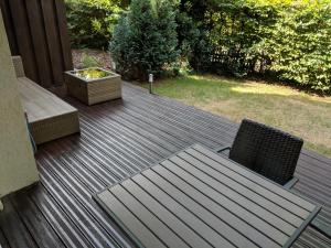 a wooden deck with two chairs and a table at 2-Zimmer-Apartment Ratingen Ost in Ratingen