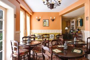 a restaurant with tables and chairs in a room at Petite Auberge in San Francisco