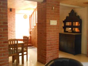a dining room with a table and a brick wall at Hostal Balmaceda La Serena in La Serena