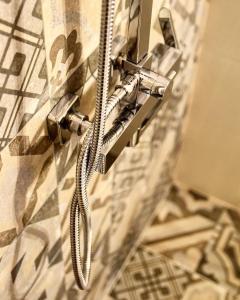 a shower head is attached to a wall at Angelos Boutique Suites in Patitiri +135 photos
