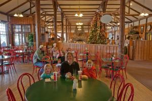 a woman and two children sitting at a table in a restaurant at YMCA of the Rockies in Estes Park