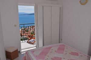 a bedroom with a bed and a view of the ocean at House Jasna in Igrane