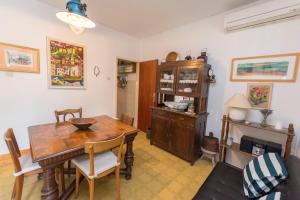 a dining room with a table and a fireplace at Apartments Ziva in Primošten