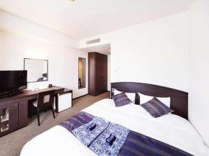 Ένα ή περισσότερα κρεβάτια σε δωμάτιο στο Silk Inn Kagoshima