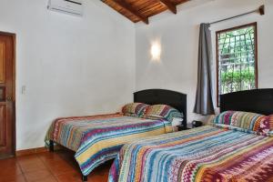 Voodi või voodid majutusasutuse Villas Macondo toas